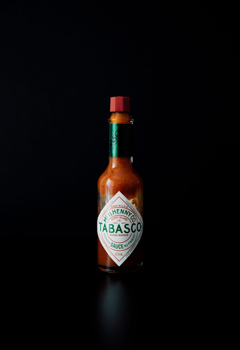 co, food and drink, tobasco, still life, perfume sprayer, indoors, glass - material, close-up, container, refreshment, tabasco, hot, wealth, spicy, no people