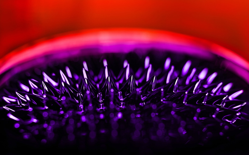 studio shot, extreme close-up, 2K, technology, pattern, indoors, full frame, warning sign, purple, sign, selective focus, focus on foreground, equipment
