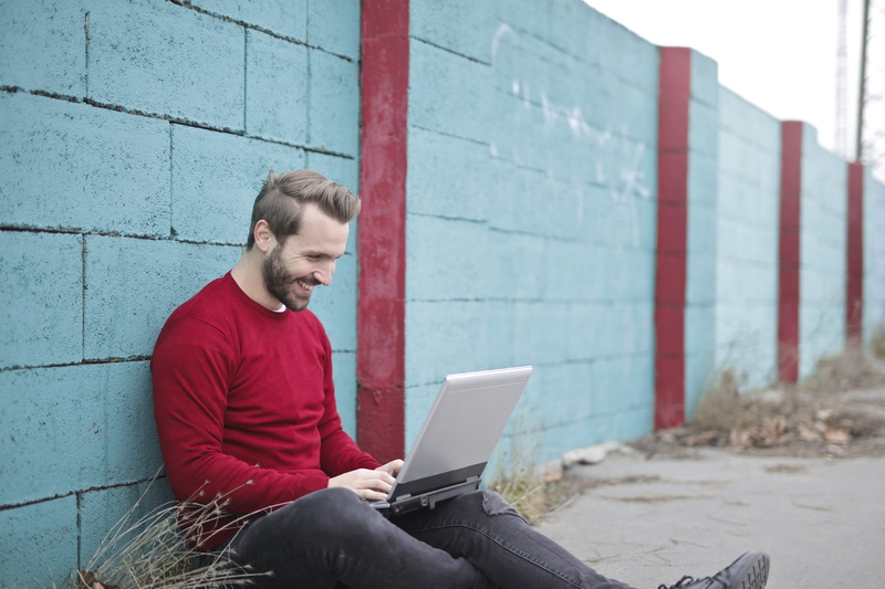 internet, day, three quarter length, computer, outdoors, urban, street, handsome, digital, portrait, person, sit, communicate, young adult, beard, joy