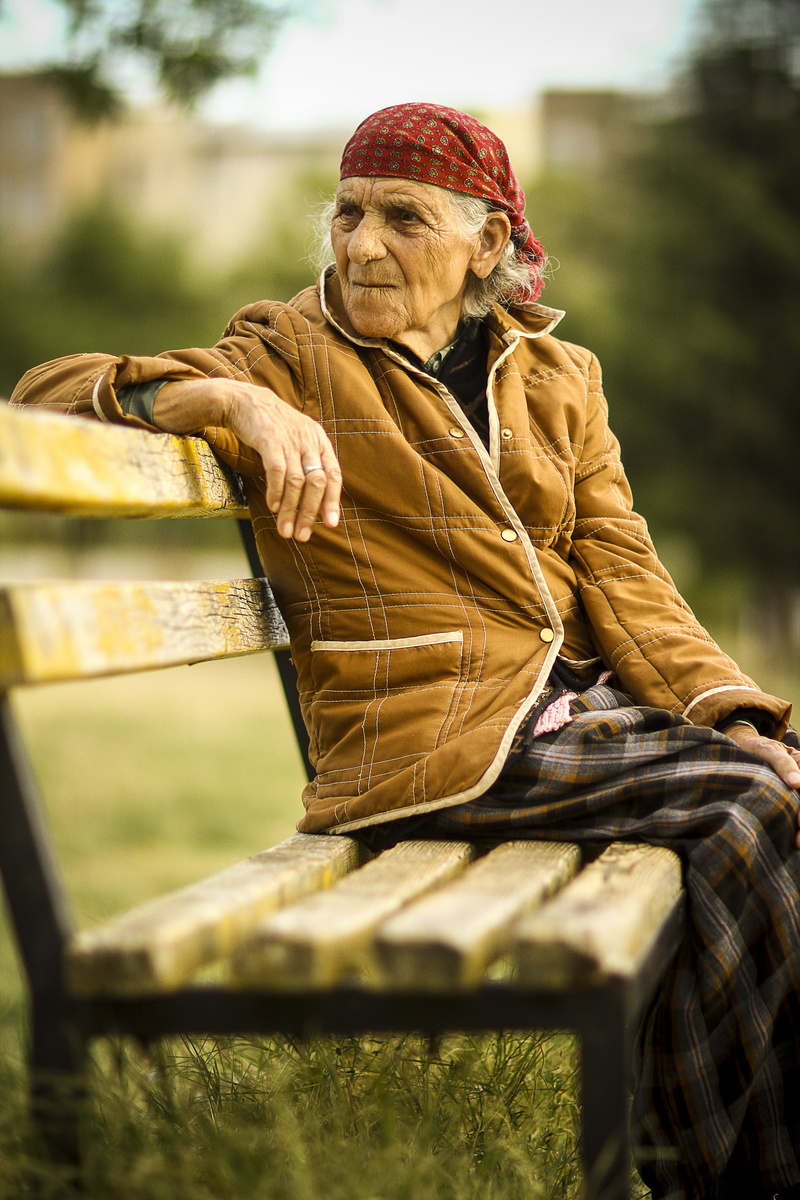 jacket, resting, sitting, clothing, outdoors, real people, plant, female, men, leisure activity, elderly, senior Adult, grandmother, focus on foreground