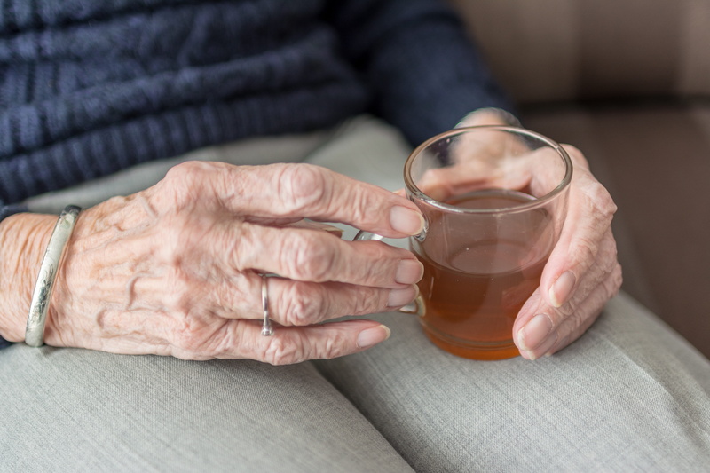 household equipment, body part, front view, one person, tea - hot drink, hands, food and drink, loneliness, tea, glass, cup of tea, midsection, drink, holding