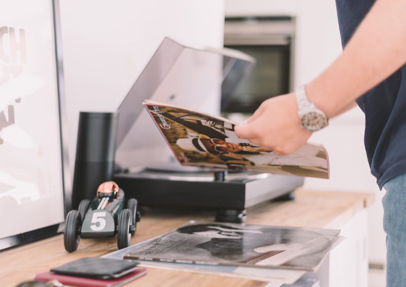 inside, reading, record, front, holding, notebook, sideboard, person, brown, side view, black, sleeve, store, 5K, midsection, well, lighted, human hand