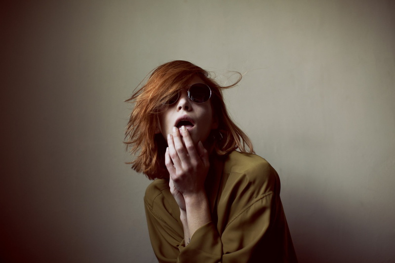 studio shot, portrait, front view, vignette, women, contemplation, fashion, beautiful woman, hands covering mouth, sunglasses, waist up, one person, headshot