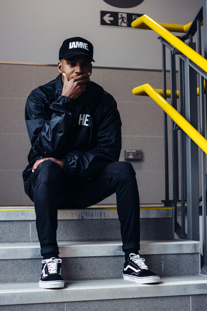 seat, man, fashion, hand, uniform, day, covering, guy, full length, cap, one person, text, seating, casual clothing, men, clothing, black color, male, government