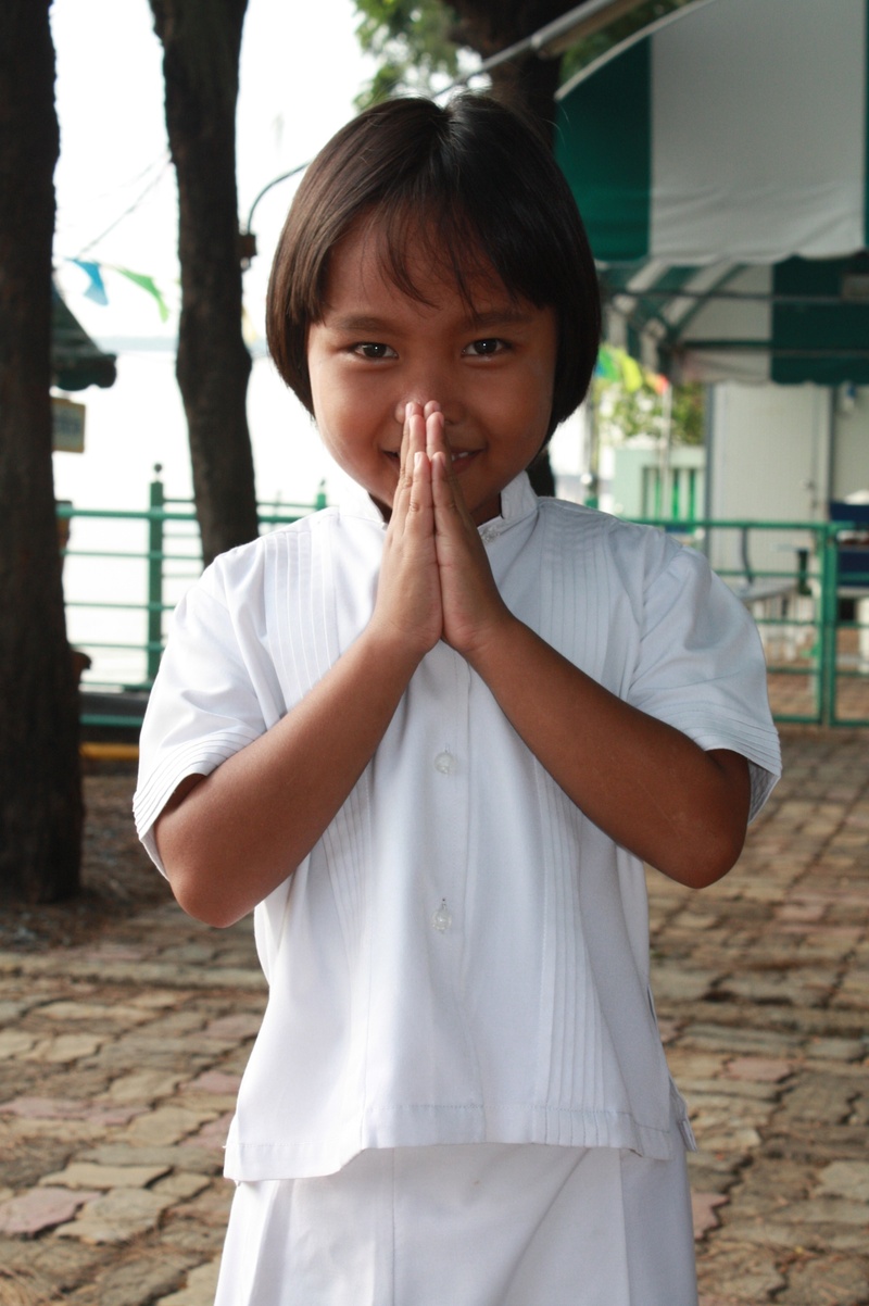 buddhism, front view, leisure activity, childhood, standing, thai, casual clothing, day, lifestyles, outdoors, child, hands covering mouth, 2K, looking at camera