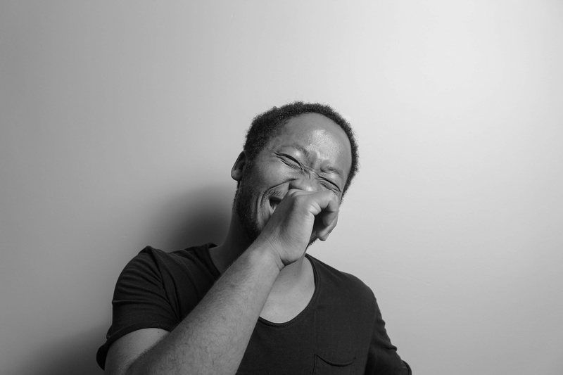 one person, man, black and white, real people, hairstyle, hands covering mouth, contemplation, front view, grayscale, leisure activity, lifestyles, portrait