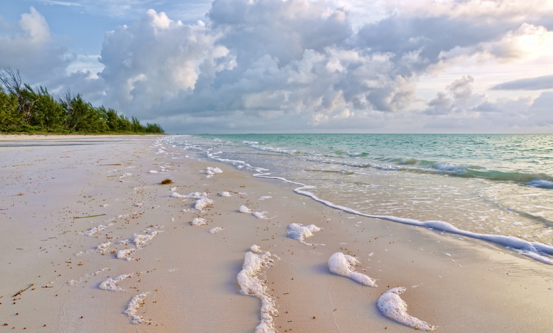 land, seascape, non-urban scene, island, wet, water, cloud - Sky, scenics, surf, white, clouds, tranquil Scene, travel, blue, sunlight, whisper, vacations