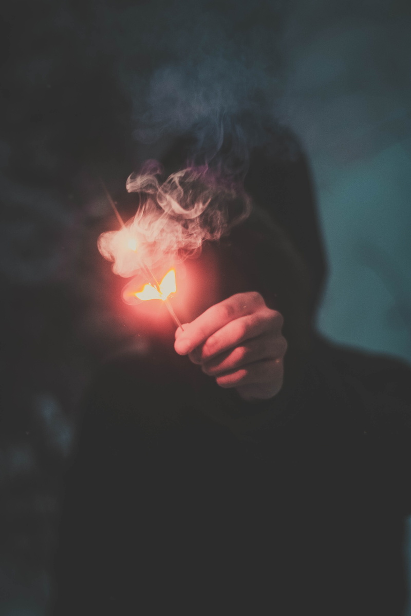 lifestyles, fire - natural phenomenon, heat - temperature, warning sign, one person, smoke - physical structure, motion, firecracker, hoodie, smoke, burning