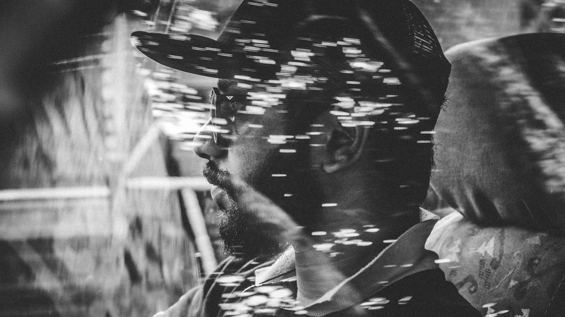 built structure, drive, vakathanam, low section, motion, window, cap, reflection, human, bokeh, standing, looking away, vehicle, window reflection, male