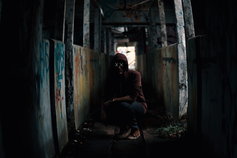 street art, 5K, cross, red, young men, casual clothing, architecture, darkness, dirty, man, wearing, hood, abandoned, clothing, sitting, social issues
