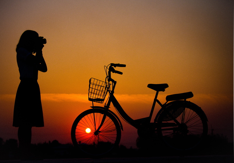standing, backlit, cyclist, orange color, bike, sunset, cute, full length, biker, lifestyles, nature, transportation, one person, silhouette, adult, summer