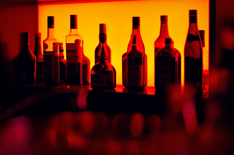 restaurant, food and drink, drinking glass, glass - material, wine bottle, bar, glass, refreshment, container, household equipment, light, neon, beer bottle