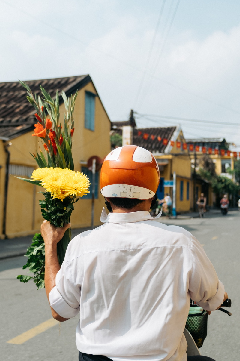 human, sunflower, motorcycle, plant, flower arrangement, one person, city, bouquet, tet, yellow, architecture, real people, hardhat, daytime, 5K, lifestyles
