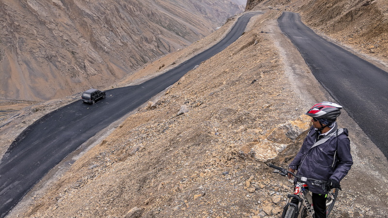 activity, clothing, human, landscape, watching, person, nature, man, day, scenics - nature, highway, dirt road, outdoors, apparel, helmet, riding, asphalt