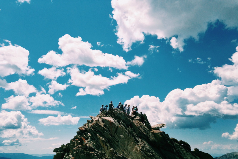 day, climb, low angle view, environment, nature, gathering, rocky, standing, adventure, clear, rock, cloud - sky, people, hiking, tranquility, outdoors