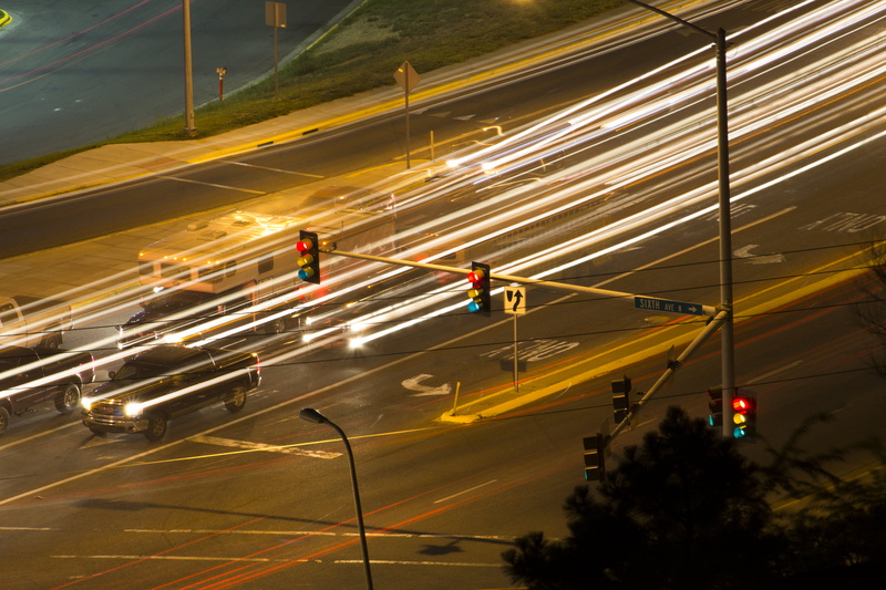 silhouette, mode of transportation, blurred motion, transportation, architecture, road signs, city life, multiple lane highway, highway, blur, city, road
