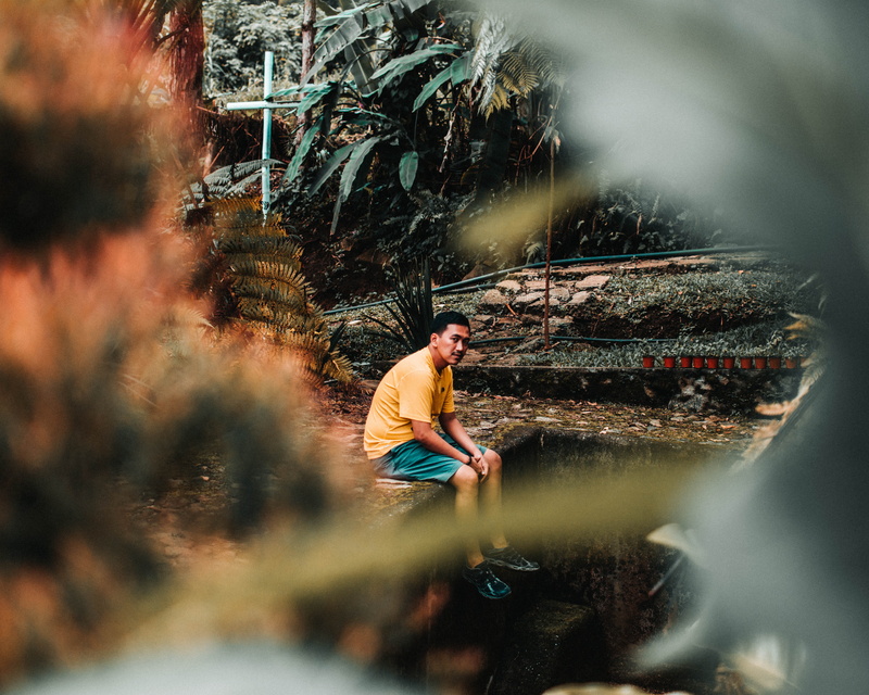 young adult, nature, selective focus, real people, lifestyles, forest, one person, light, water, day, men, apparel, adult, casual clothing, tree, person