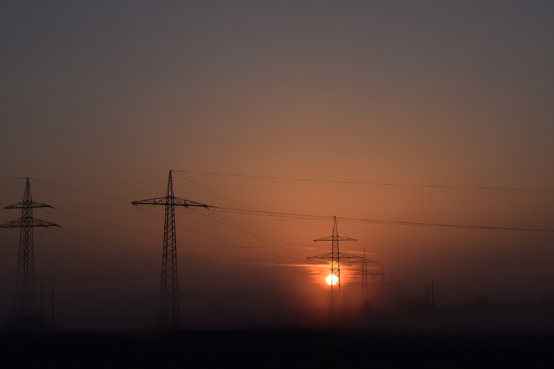 sunset, sun and energy, low angle view, skies, sky, electricity, scenics - nature, power poles, solar power, romantic sky, orange color, power line, silhouette