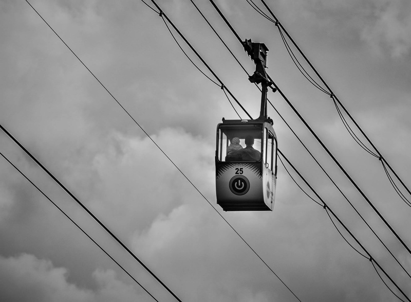 connection, man, black white, cloud - sky, safety, hanging, day, ropes, contrast, mode of transportation, child, sky, overhead cable car, technology, sign