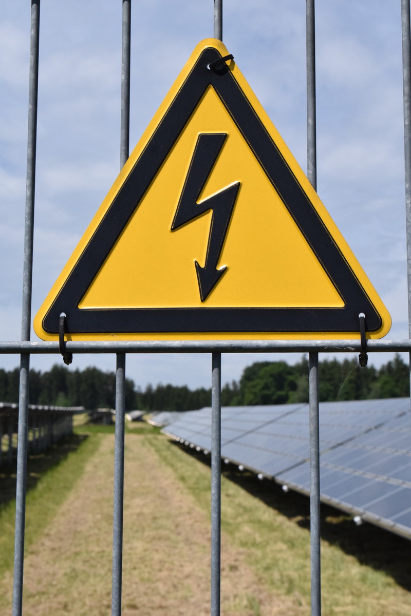 light, focus on foreground, warning symbol, cloud - sky, high voltage, yellow, nature, safety, arrow symbol, solar system, sun, security, outdoors, protection