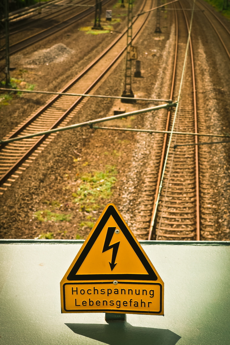 flash of lightning, transportation, sign, electricity, communication, power line, high voltage sign, energy, railway, text, current, risk, train, road warning sign