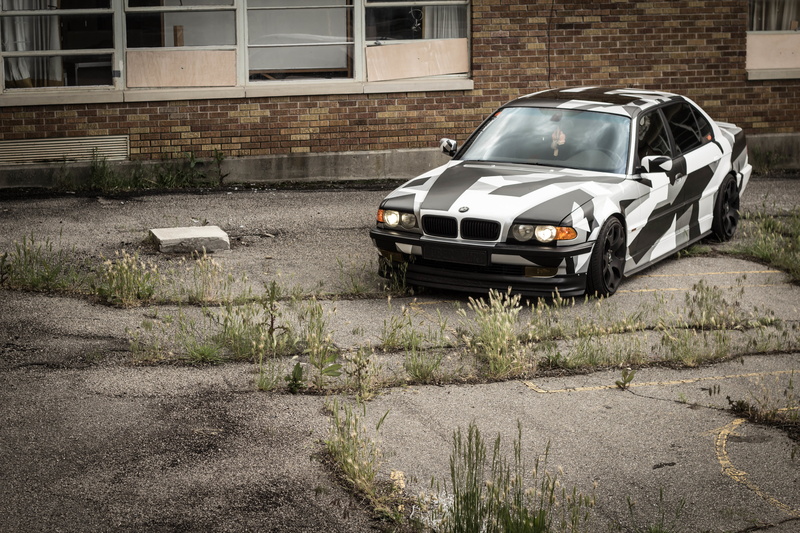 day, land vehicle, city, mode of transportation, no people, garage, camo, arctic camo, building, E38, motor vehicle, built structure, car, plant, witer