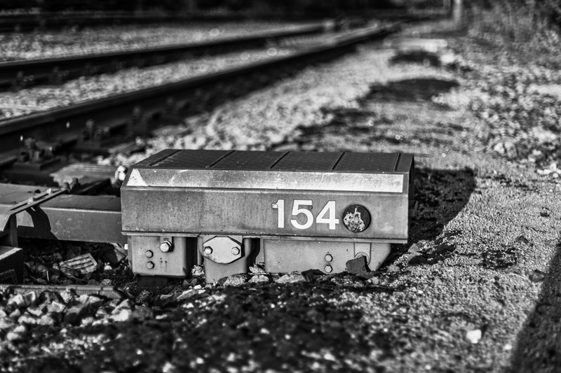 outdoors, communication, railroad track, selective focus, focus on foreground, railway, close-up, number, industrial, day, rail, field, railroad, light