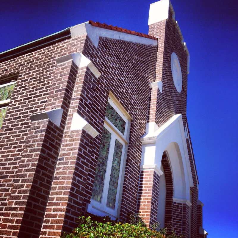 sunlight, outdoors, building exterior, city, building, residential district, old, exterior, brick wall, clear sky, office building exterior, wall, worship