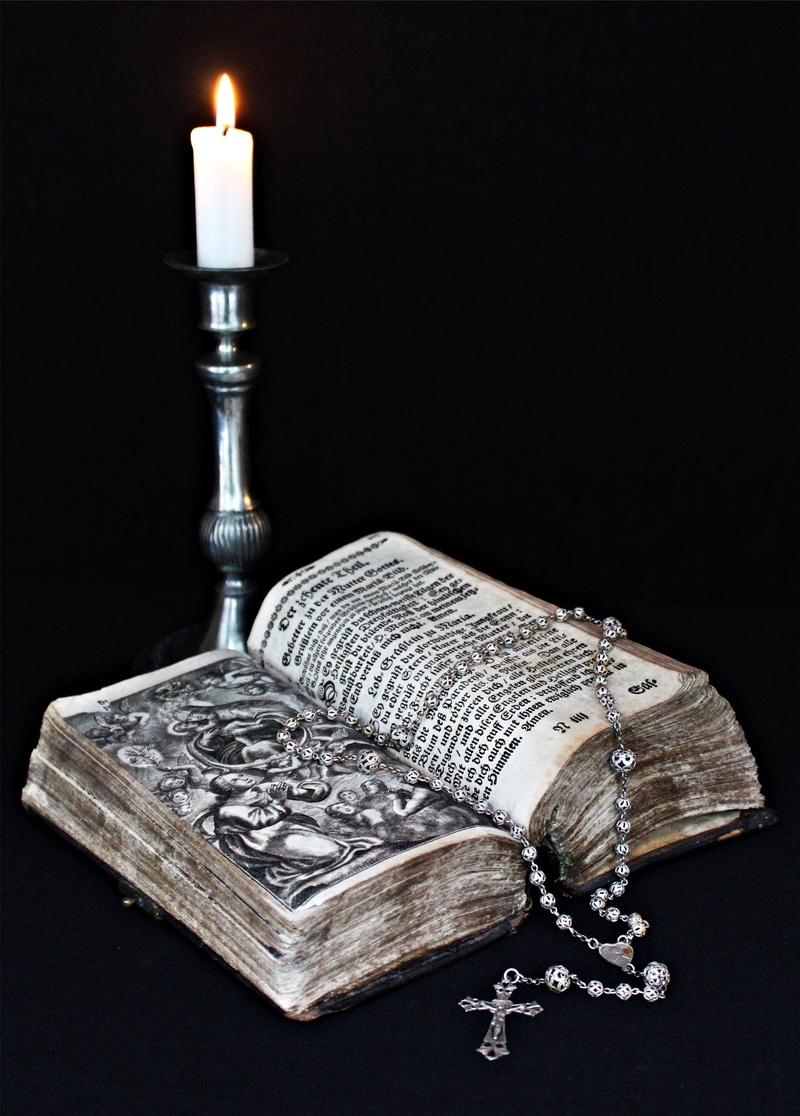 paper currency, luxury, the holy book, believe, christianity, table, fire, black background, the past, black color, no people, faith, church, close-up