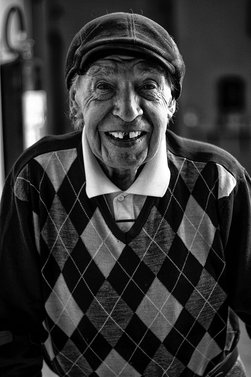 facial expression, front view, leisure activity, face, standing, teeth, hat, pose, sweater, looking at camera, making a face, portrait, wearing, senior men