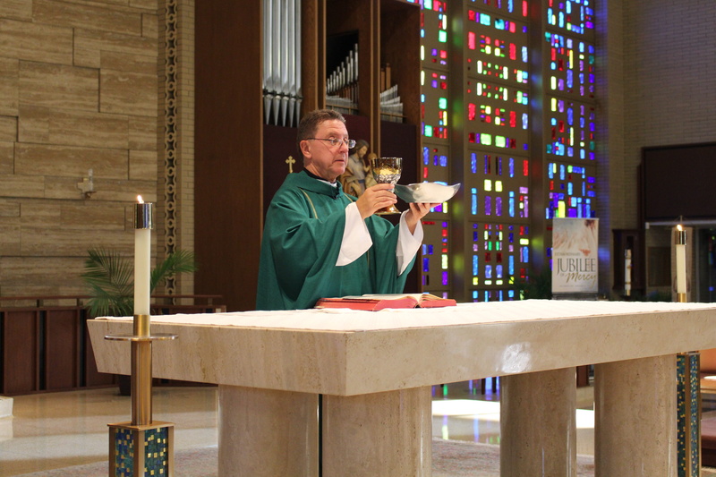 5K, book, chalice, church, table, adult, leisure activity, wood - material, catholic, liturgy, holding, lifestyles, waist up, one person, real people