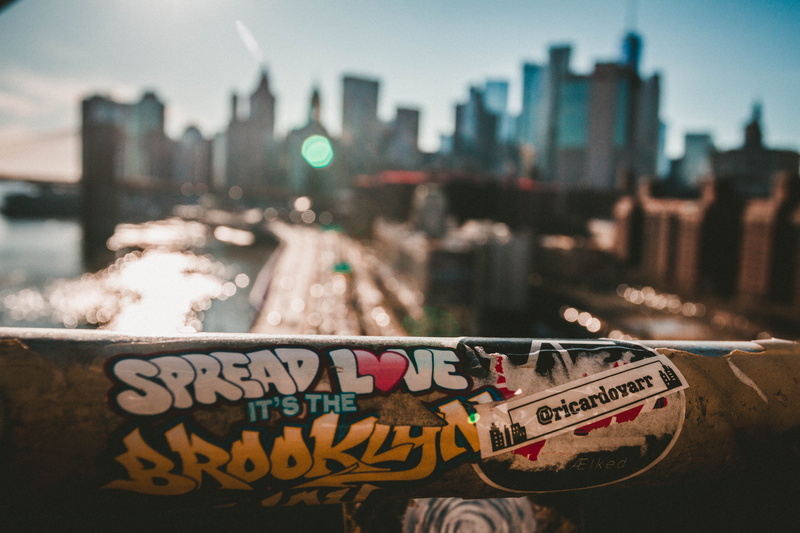 river, focus on foreground, manhattan, skyscraper, urban skyline, outdoors, building, western script, sky, built structure, building exterior, communication