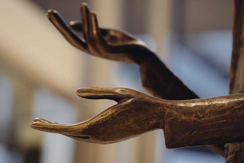 art and craft, animal representation, close-up, indoors, metal, hanging, bronze, craft, wooden, mammal, selective focus, hands, animal, day, side view