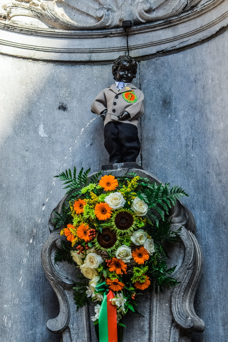 sculpture, indoors, no people, manneken pis, bouquet, nature, flower, male likeness, bronze, spirituality, belief, landmark, belgium, human representation
