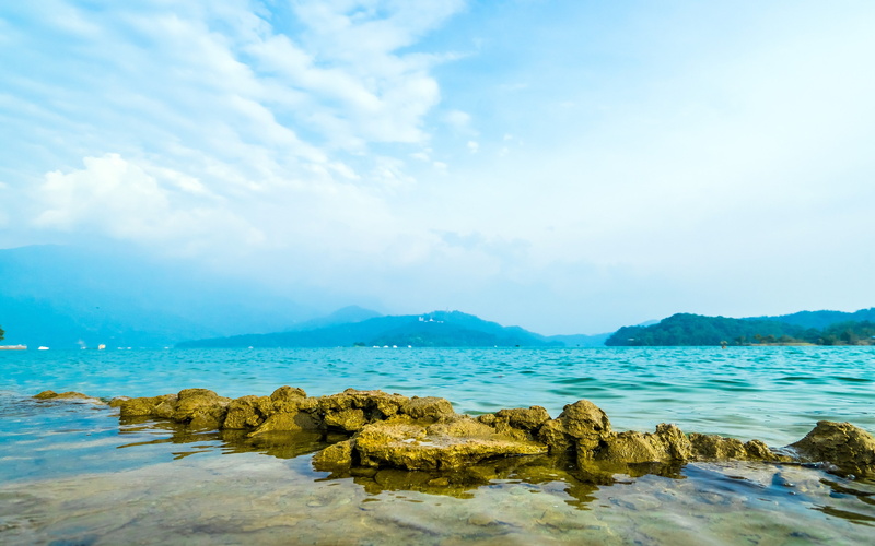 blue, rocky coastline, tranquil scene, waterfront, beauty in nature, outdoors, sea, water, tranquility, sun, rock - object, cloud - sky, nature, beach