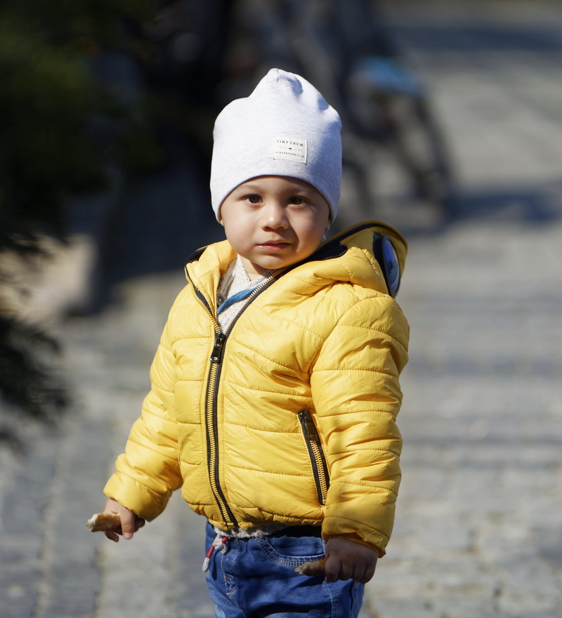 real people, front view, men, 2K, sad, warm clothing, males, day, boys, three quarter length, small, expression, the person, boy, lifestyles, outdoors