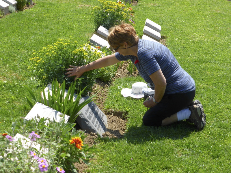 death, nature, day, outdoors, graveyard, loss, remembrance, mourning, flower, real people, full length, mourn, leisure activity, gardening, grass, sorrow
