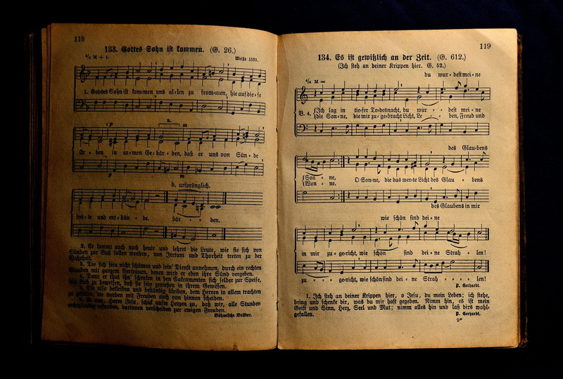 book, open, old-fashioned, black background, arts culture and entertainment, religious Text, sheets, page, high angle view, sing, song book, single object