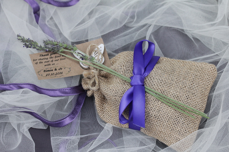 tied up, furniture, indoors, sheet, ribbon, one animal, textile, plant, animal, clothing, 5K, close-up, no people, purple, flower, decoration, ribbon - sewing item