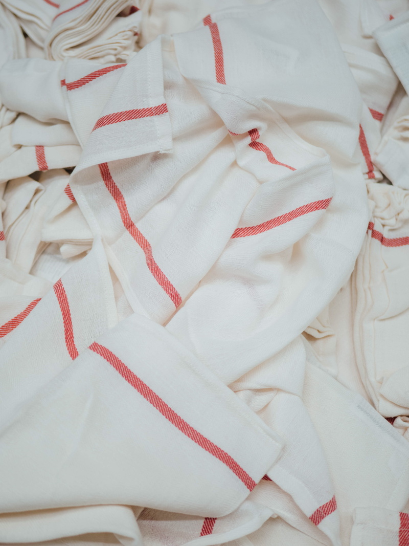 textiles, embroidery, bed, still life, red, indoors, floral pattern, textile, ribbon, white, pattern, full frame, clothing, material, close-up, backgrounds