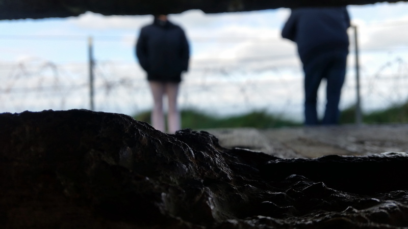 solid, unrecognizable person, environment, stone, day, land, blurred shot, men, rock, nature, standing, rear view, france, focus on foreground, saint-laurent-sur-mer