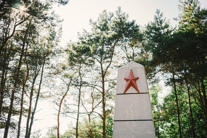 architecture, green color, victory, tree, day, war, branch, latvia, religion, cemetery, building exterior, stone, symbol, human representation, spirituality
