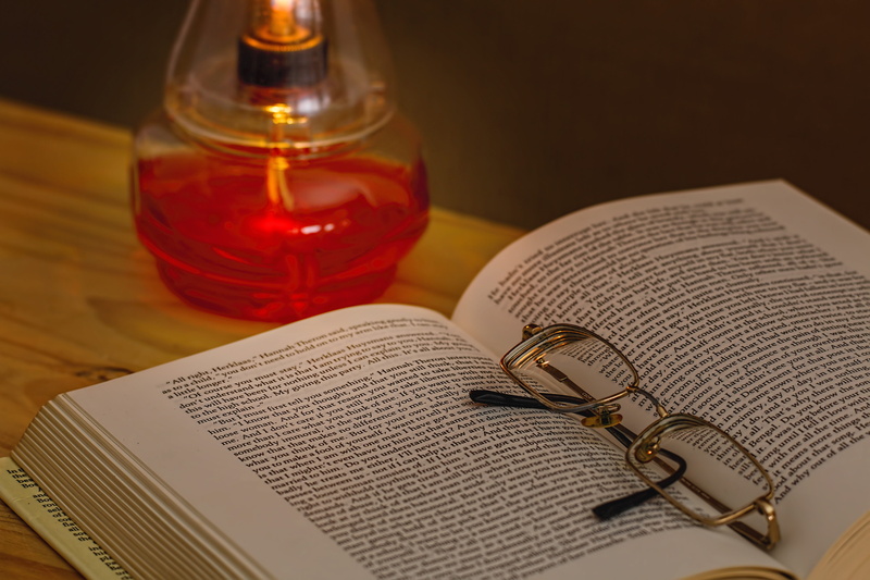 paper, 5K, focus on foreground, dark, lamp, table, in between, silver, fragrance, high angle view, reading glasses, reading, no people, open book, education