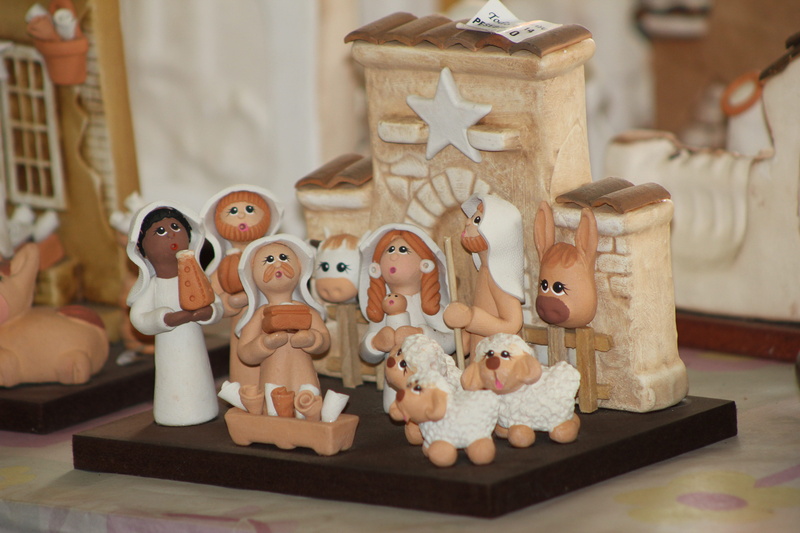 large group of objects, no people, indoors, 5K, human representation, people, art, figurine, still life, female likeness, manger, table, craft, focus on foreground