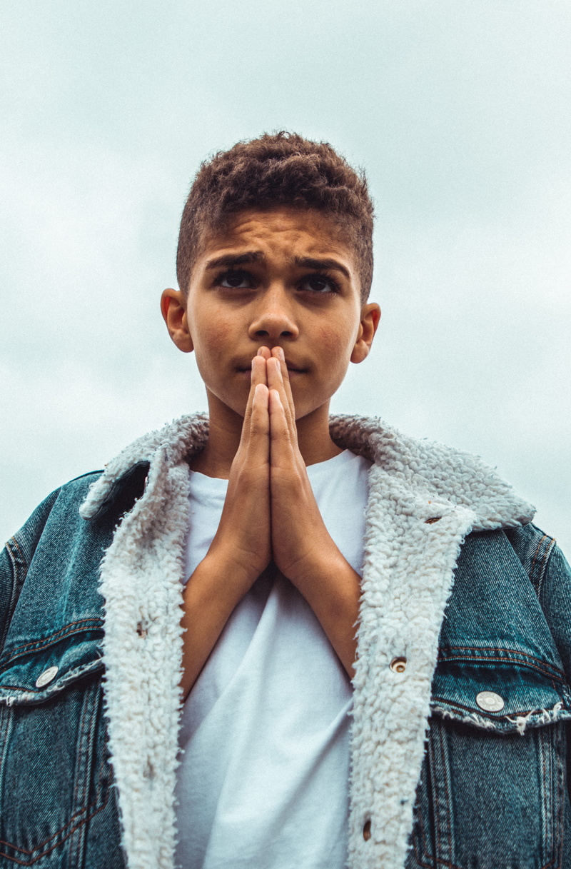 lifestyles, fashion, young adult, man, young men, finger, front view, sky, waist up, human, prayer, standing, warm clothing, model, apparel