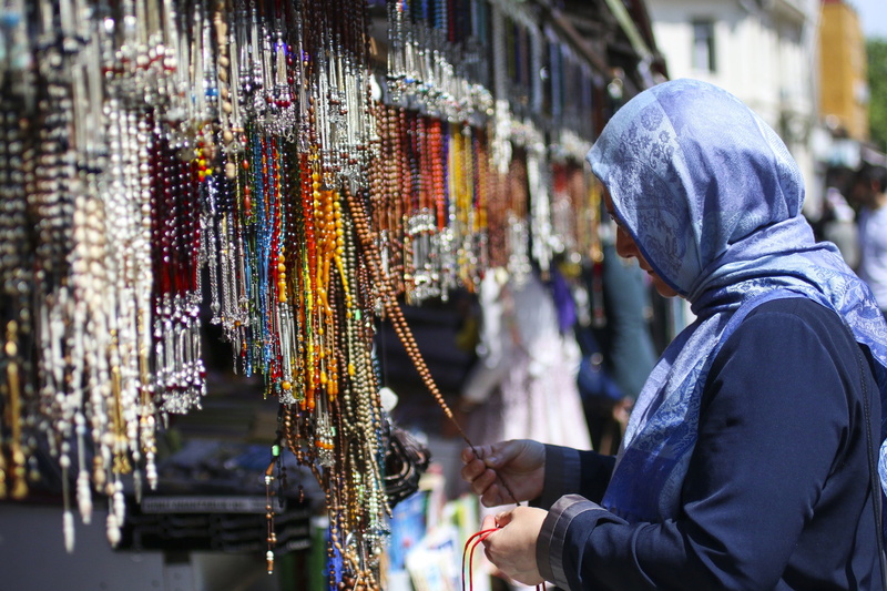 real people, adult, hood - clothing, city, indoors, side view, islam, warm clothing, focus on foreground, men, retail display, religion, for sale, architecture