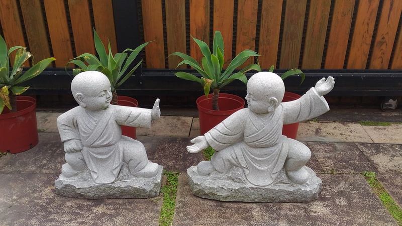 novice monk, sculpture, outdoors, stone carving, craft, no people, creativity, representation, male likeness, spirituality, statue, potted plant, human representation