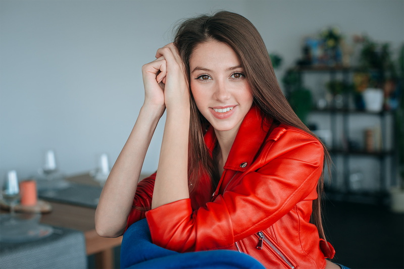 indoors, depth of field, leather jackets, face, jacket, drinking glass, women, table, brunette, looking at viewer, long hair, 1080P, red jackets, sitting