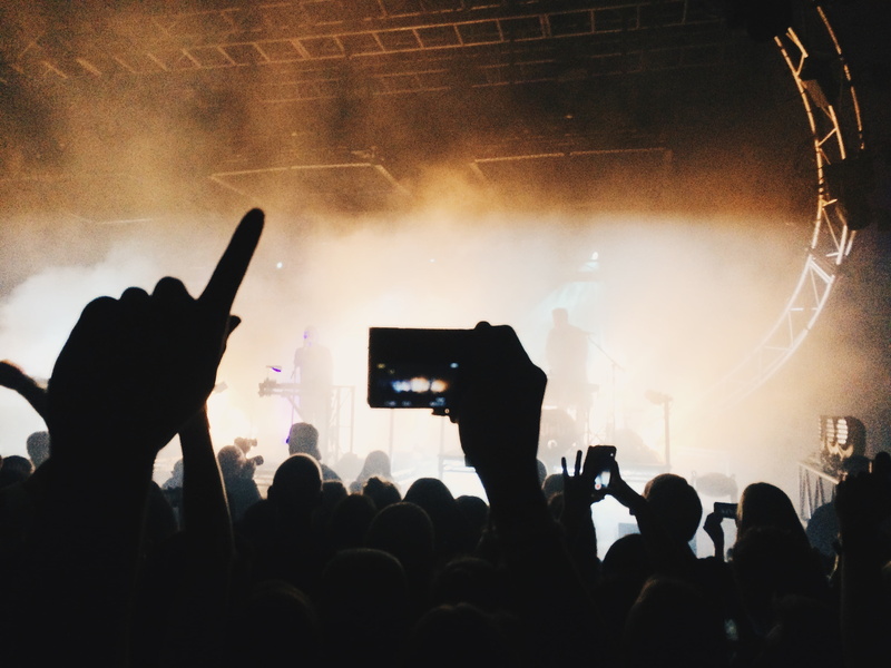 performer, performance, arts culture and entertainment, smoke, excitement, popular music concert, camera, music, group of people, human arm, smart phone