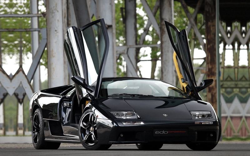 focus on foreground, drives, 1080P, black color, 6.0, city, silver colored, stationary, Lamborghini, Diablo, no people, parking, mode of transportation